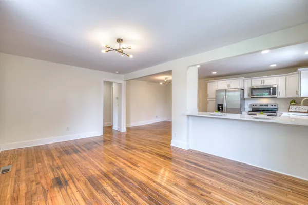 a kitchen with refrigerator and microwave