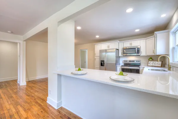 a view of a kitchen with wooden floor