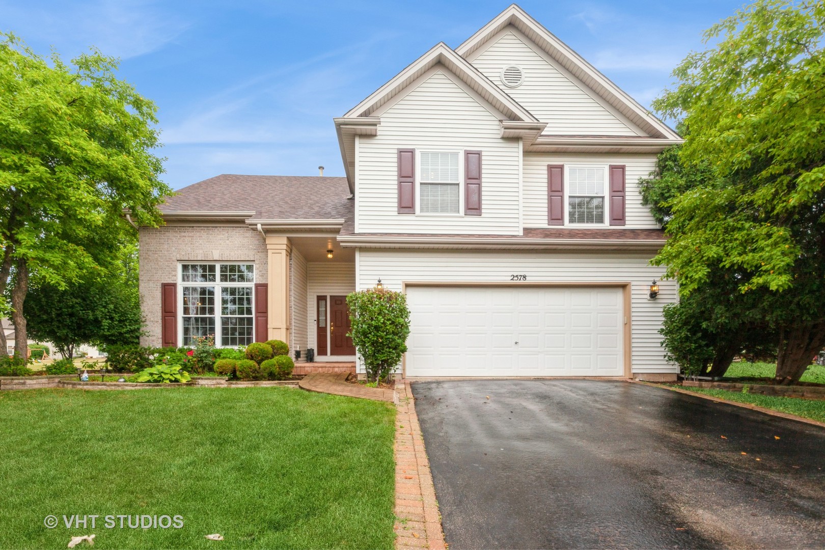 2578 Crestview Drive Aurora, IL 60502 - Photo 1 of 43 a view of a white house next to a yard and potted plants