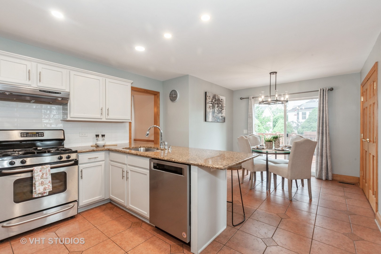 2578 Crestview Drive Aurora, IL 60502 - Photo 5 of 43 a kitchen with a stove a sink a dining table and chairs