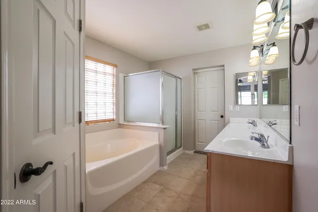 a bathroom with a tub sink and mirror