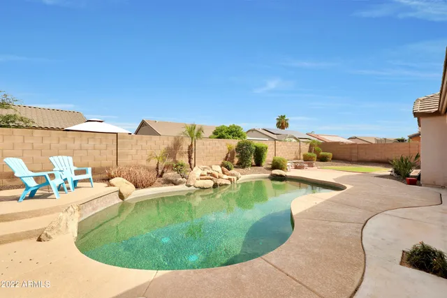 a view of a swimming pool with an outdoor seating