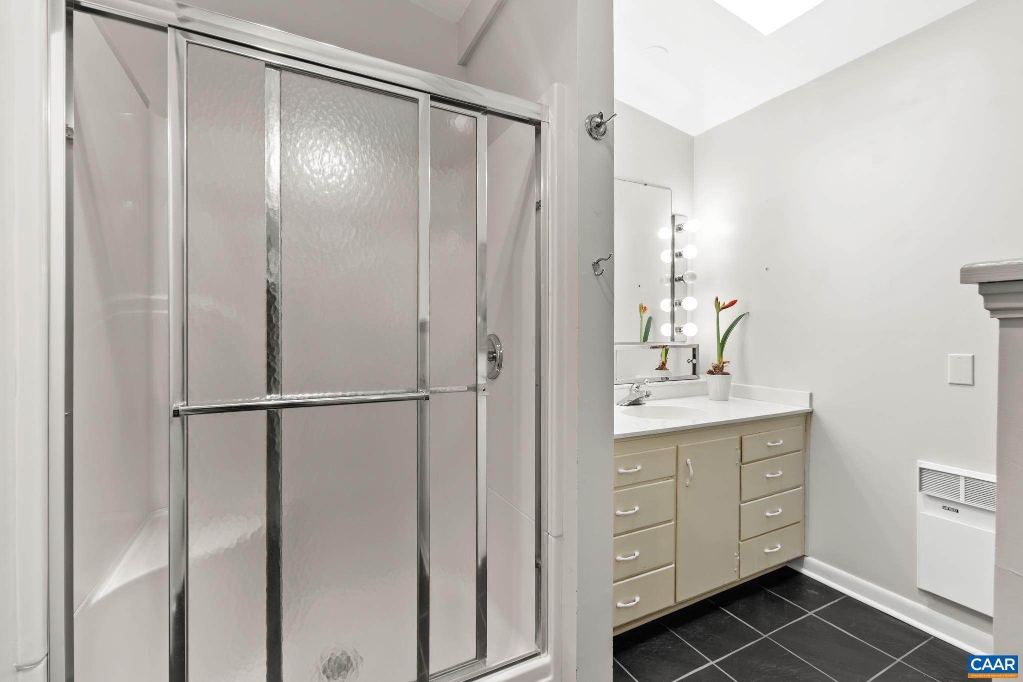 7098 Bucks Elbow Mountain Road Crozet, VA 22932 - Photo 33 of 57 a bathroom with a granite countertop sink mirror and a shower