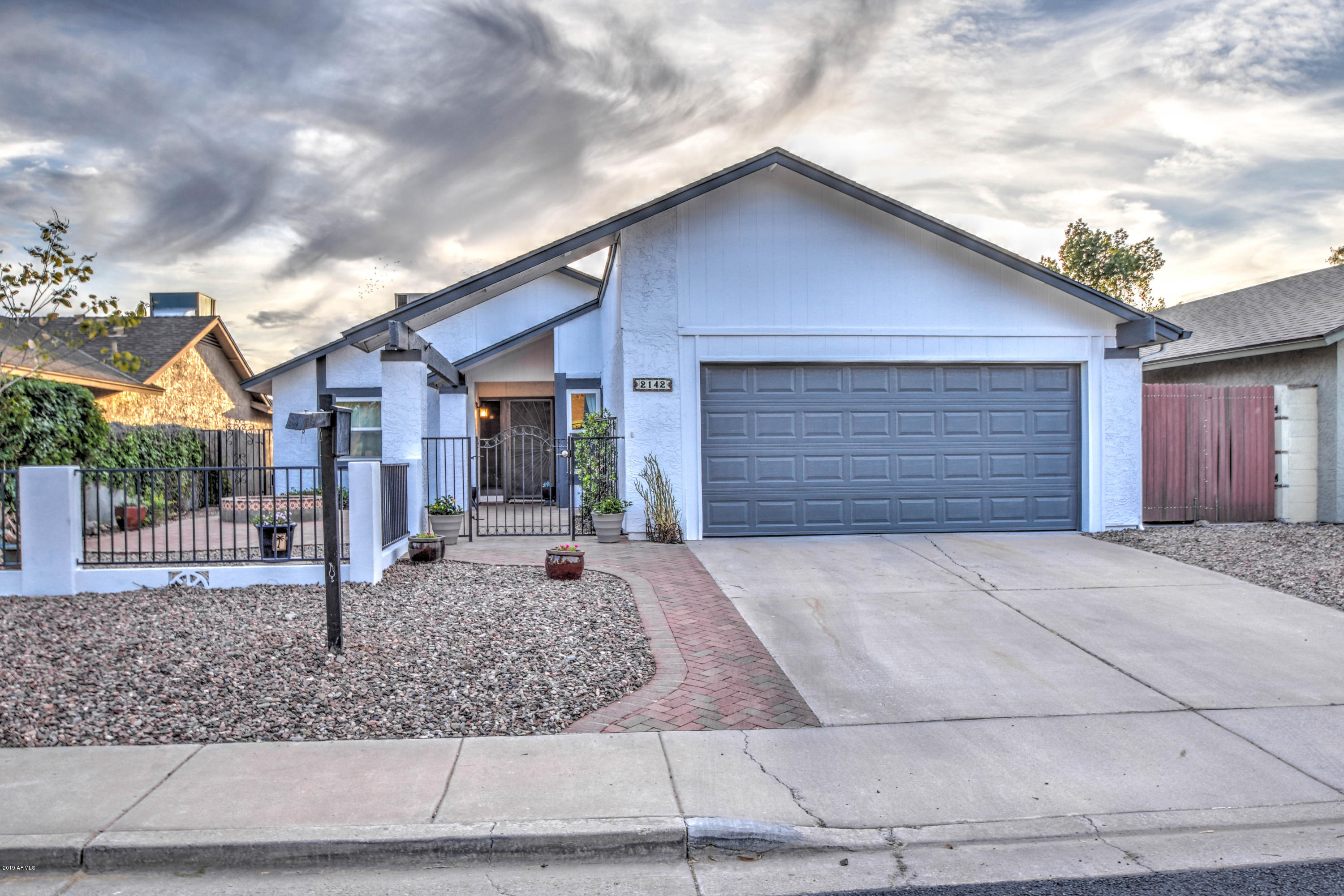 2142 West Inlet Loop Mesa, AZ 85202 - Photo 2 of 70 a front view of a house with garden