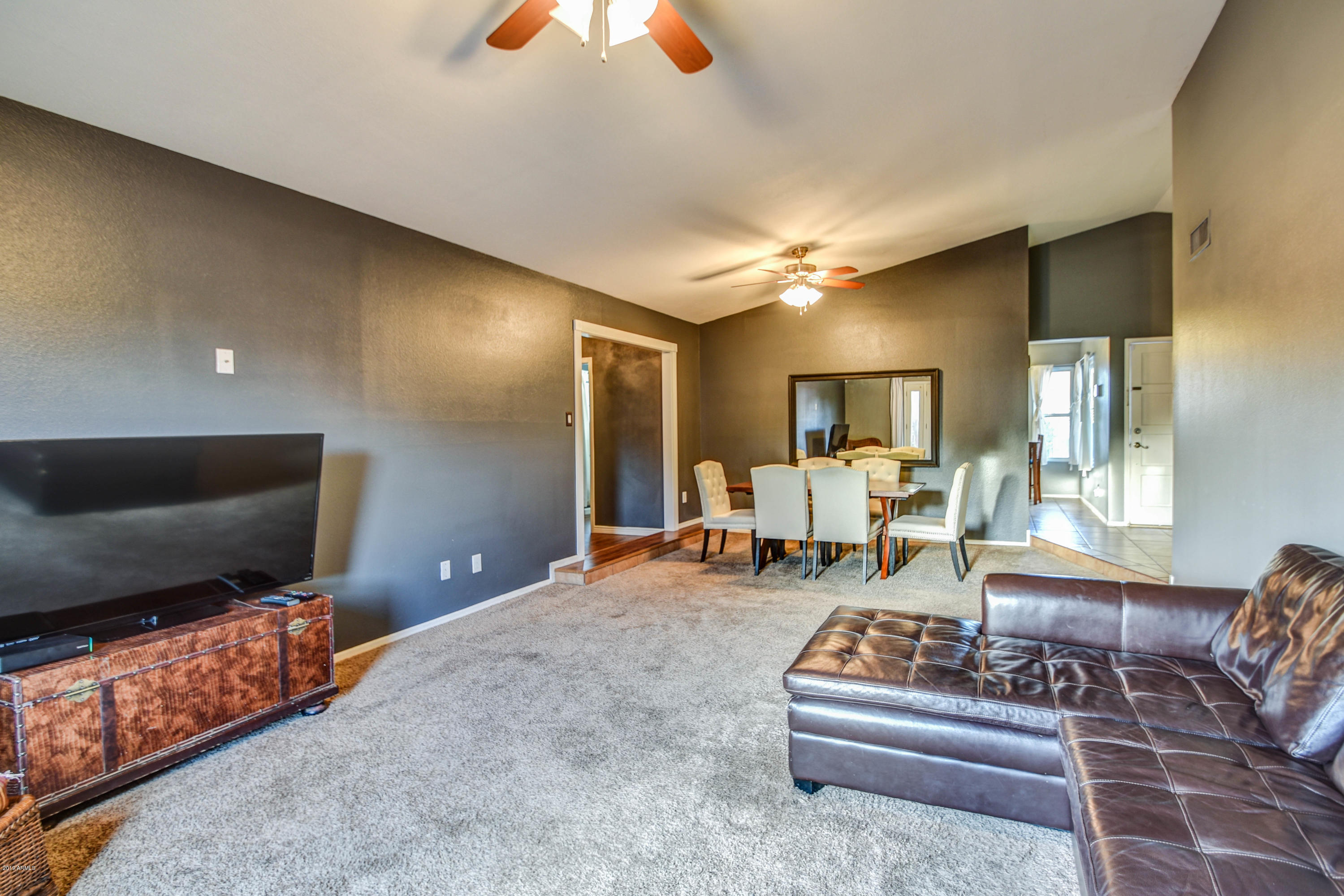 2142 West Inlet Loop Mesa, AZ 85202 - Photo 34 of 70 a living room with furniture and a flat screen tv