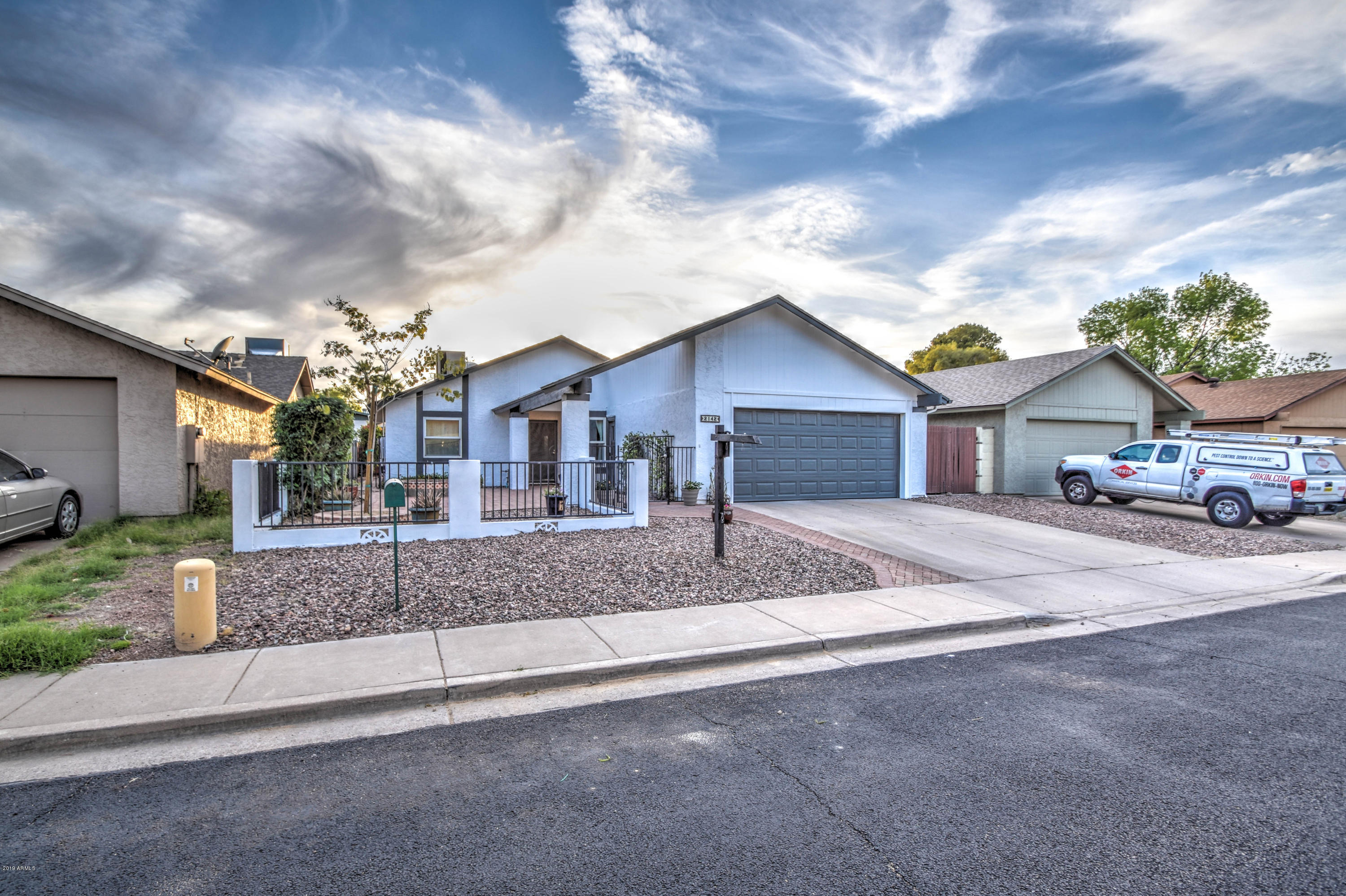 2142 West Inlet Loop Mesa, AZ 85202 - Photo 4 of 70 a front view of a house with a yard and garage