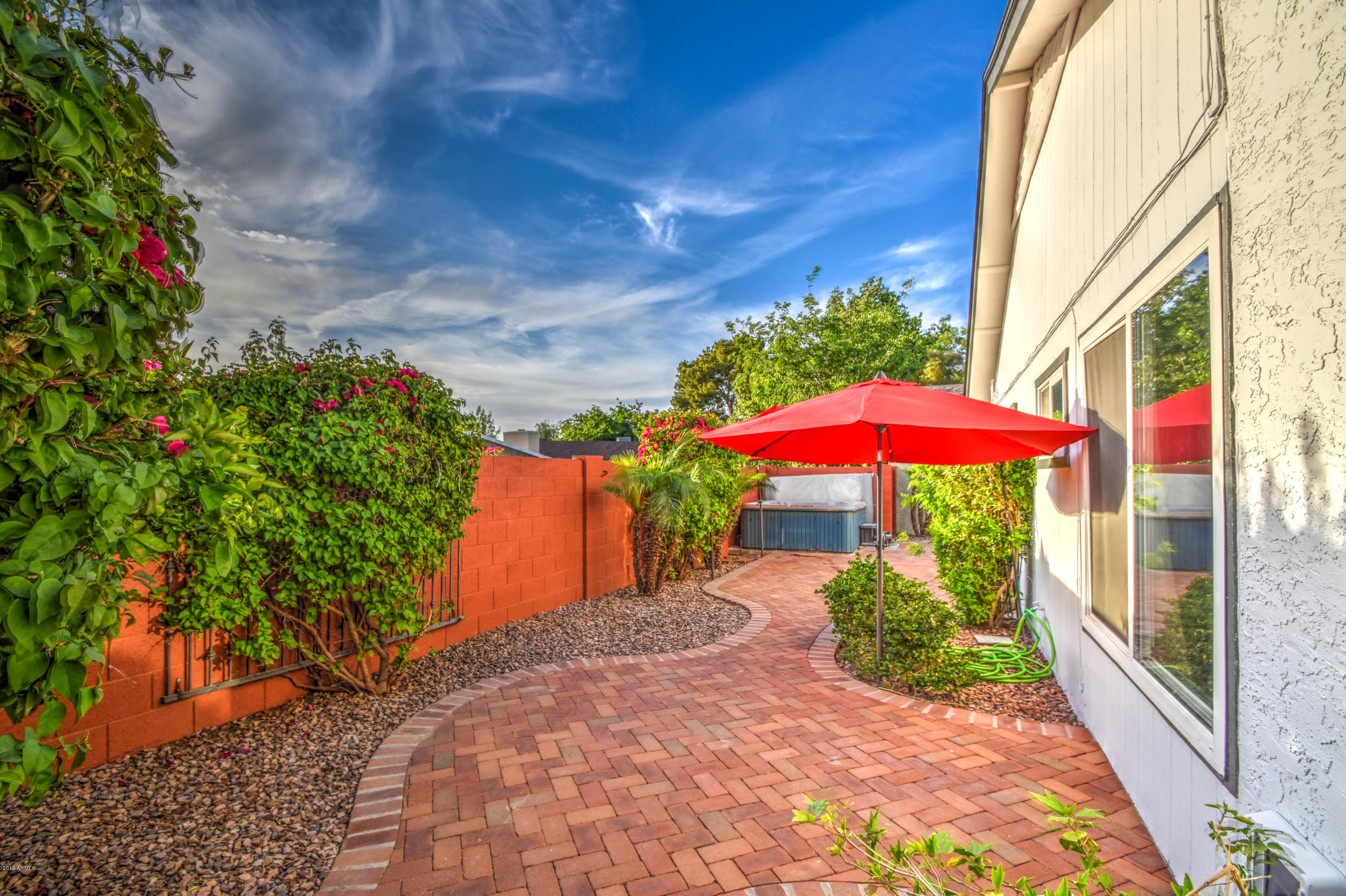 2142 West Inlet Loop Mesa, AZ 85202 - Photo 44 of 70 a view of a patio with a table and chairs under an umbrella