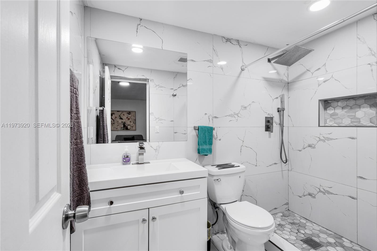 977 Southwest 10th Street, Unit 927 Miami, FL 33130 - Photo 11 of 18 a bathroom with a sink toilet vanity and shower