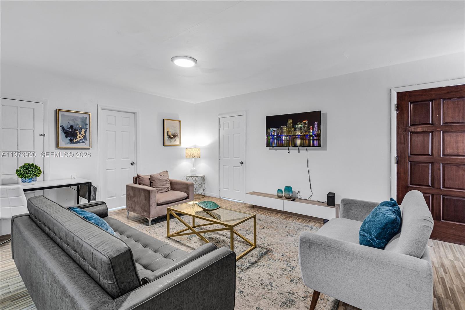 977 Southwest 10th Street, Unit 927 Miami, FL 33130 - Photo 2 of 18 a living room with furniture and a table