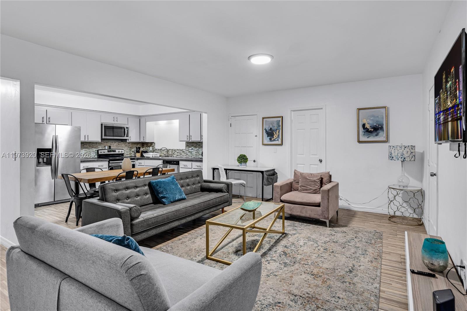 977 Southwest 10th Street, Unit 927 Miami, FL 33130 - Photo 3 of 18 a living room with furniture and a view of kitchen