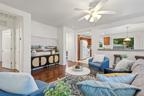 a living room with furniture and wooden floor