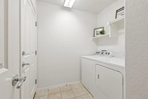 a front view of a house with a garden and yard