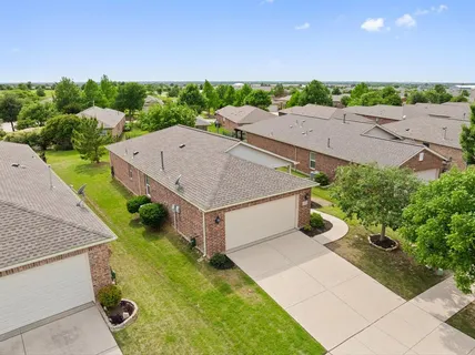 an aerial view of multiple houses with yard