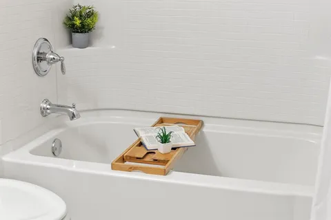 an empty room with a window and a ceiling fan