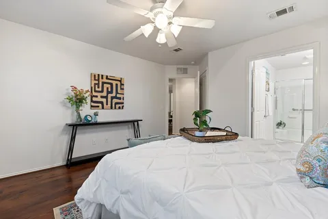 a bedroom with a bed and wooden floor