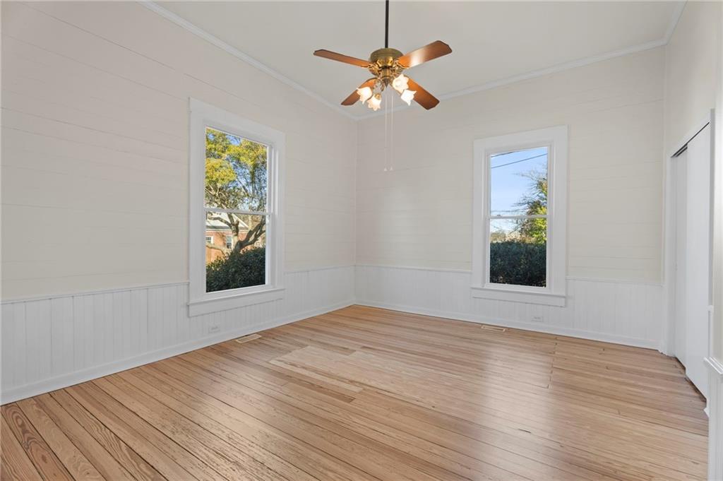 114 Cleveland Street McDonough, GA 30253 - Photo 12 of 71 a view of an empty room with a window and wooden floor