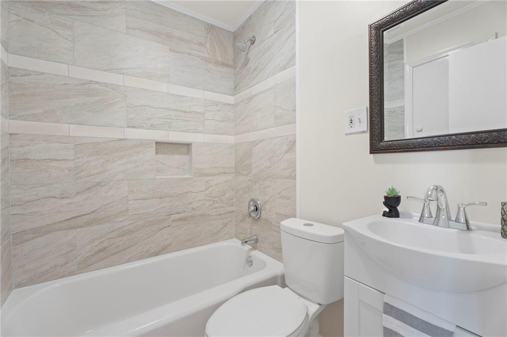 114 Cleveland Street McDonough, GA 30253 - Photo 15 of 71 a bathroom with a toilet a sink and bathtub