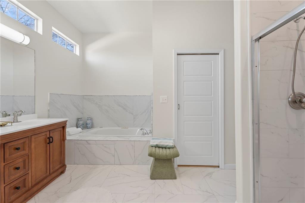 114 Cleveland Street McDonough, GA 30253 - Photo 19 of 71 a bathroom with a bathtub and sink