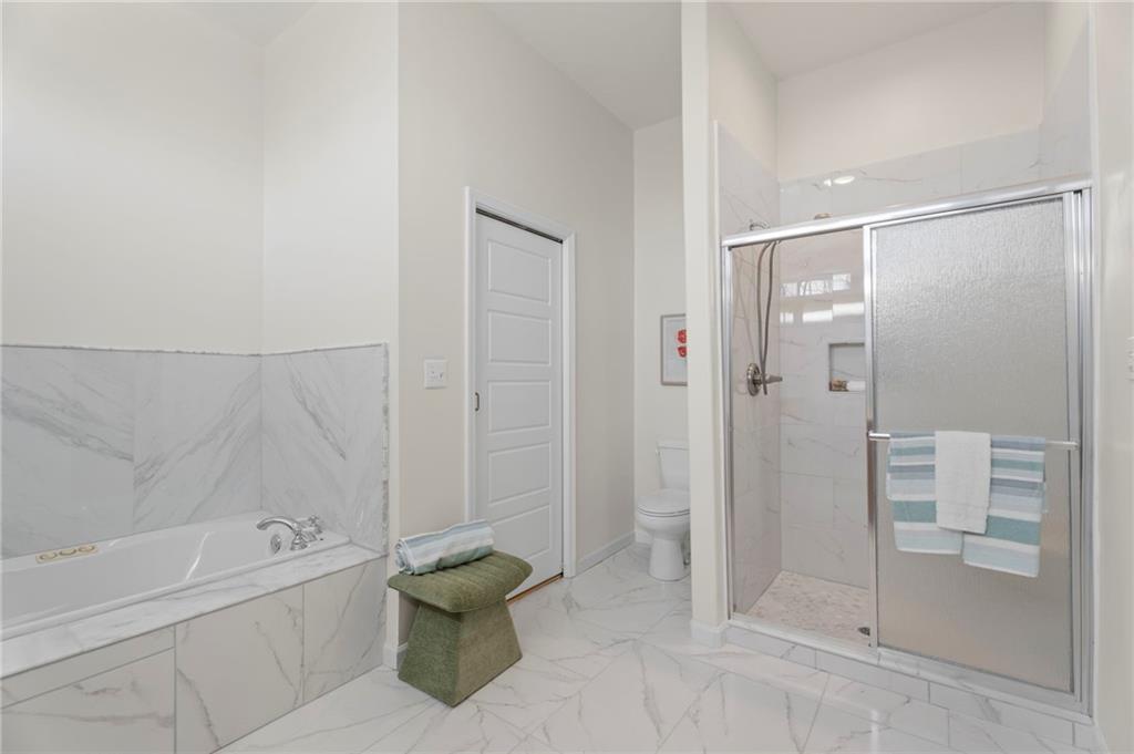 114 Cleveland Street McDonough, GA 30253 - Photo 20 of 71 a bathroom with a bathtub and a shower