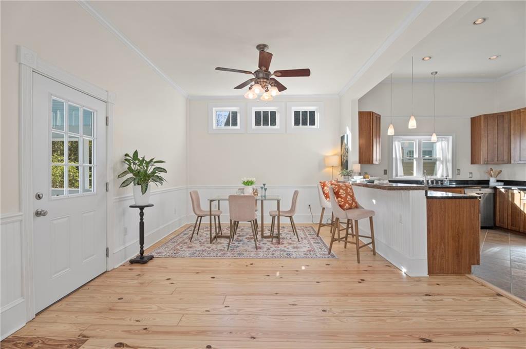 114 Cleveland Street McDonough, GA 30253 - Photo 30 of 71 a dining room with wooden floor a chandelier a wooden table and chairs