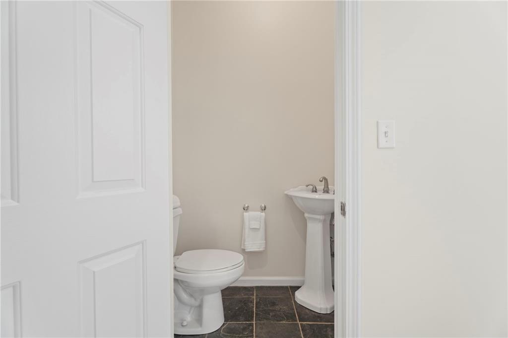 114 Cleveland Street McDonough, GA 30253 - Photo 35 of 71 a white toilet sitting next to a white cabinet