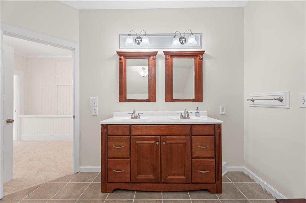 114 Cleveland Street McDonough, GA 30253 - Photo 53 of 71 a bathroom with a sink a mirror and a vanity