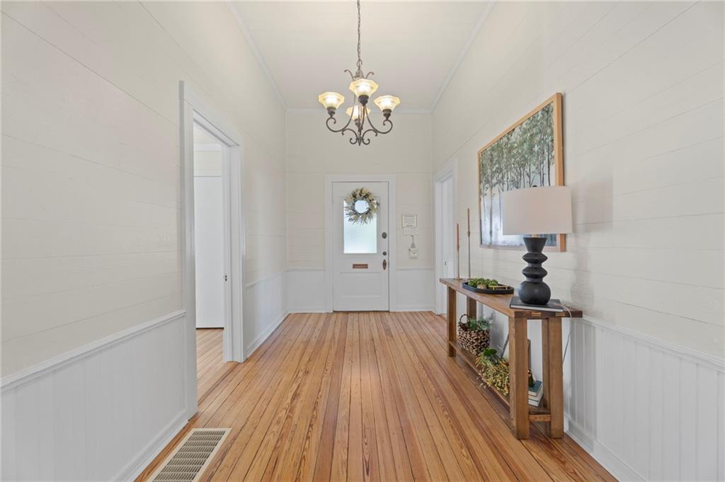 114 Cleveland Street McDonough, GA 30253 - Photo 9 of 71 a view of a room with wooden floor staircase and a chandelier