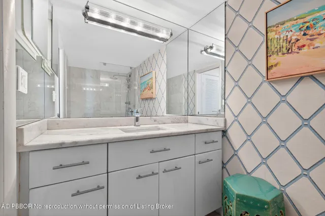 a bathroom with a granite countertop sink a toilet and a shower curtain