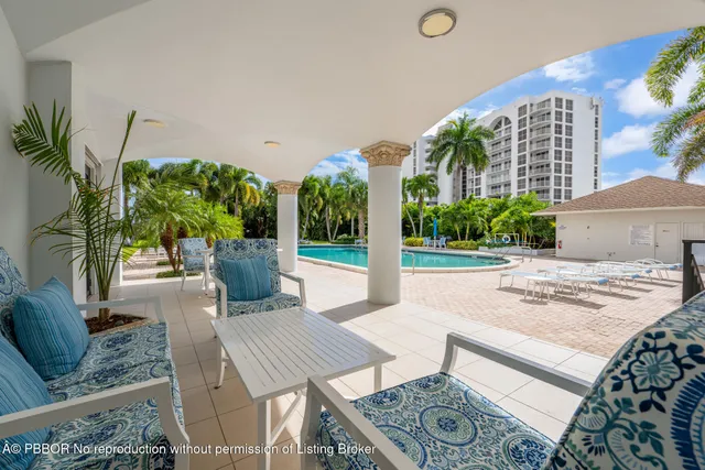 a view of a patio with couches and table with potted plants