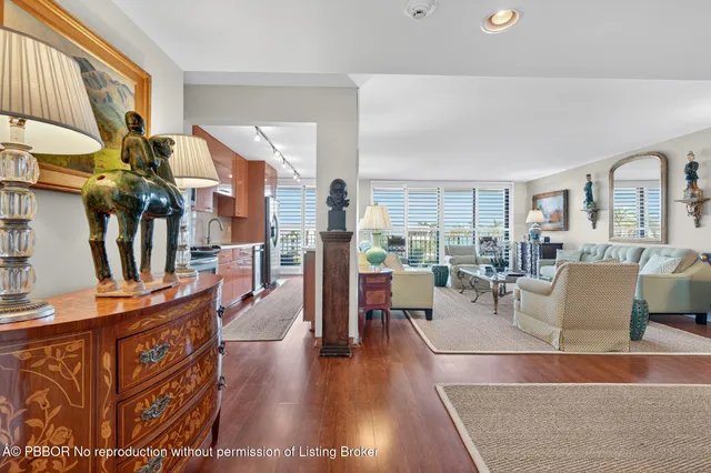a living room with fireplace furniture and a rug