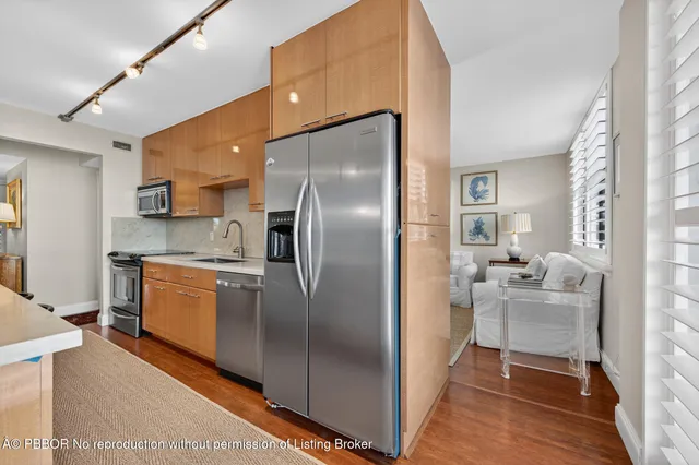 a kitchen with a refrigerator and a sink