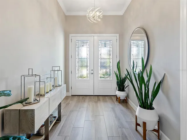a bedroom with a large bed and a flat tv screen on dresser