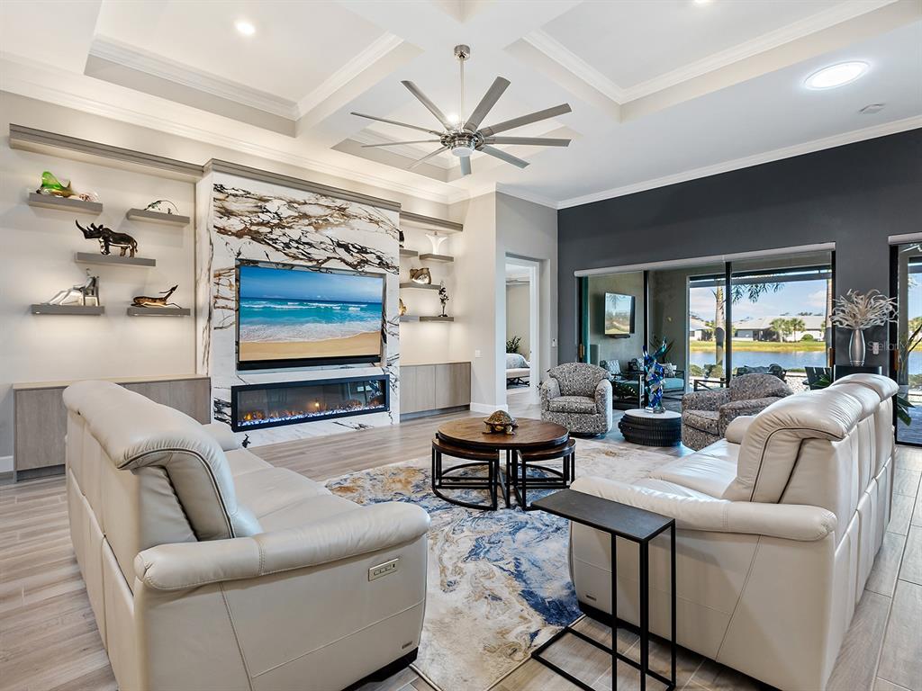 17807 Eastbrook Terrace Lakewood Ranch, FL 34202 - Photo 20 of 92 a living room with furniture a ceiling fan and a window