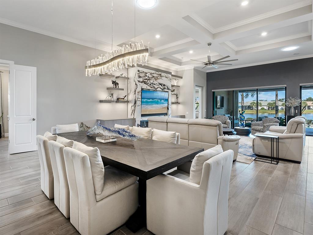 17807 Eastbrook Terrace Lakewood Ranch, FL 34202 - Photo 26 of 92 a view of a dining room with furniture and wooden floor