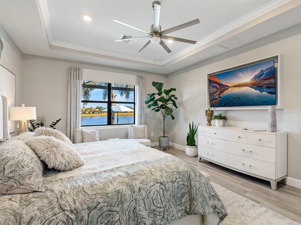 17807 Eastbrook Terrace Lakewood Ranch, FL 34202 - Photo 38 of 92 a bedroom with a bed and a flat screen tv