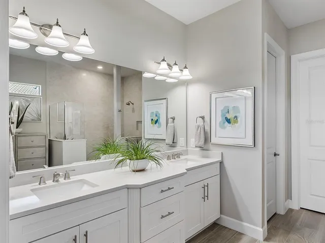 an aerial view of a house with a garden and lake view