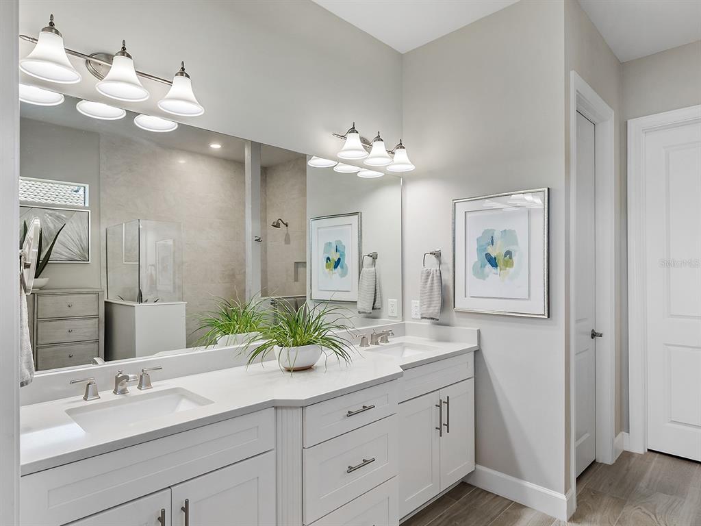 17807 Eastbrook Terrace Lakewood Ranch, FL 34202 - Photo 40 of 92 a bathroom with a double vanity sink and a mirror