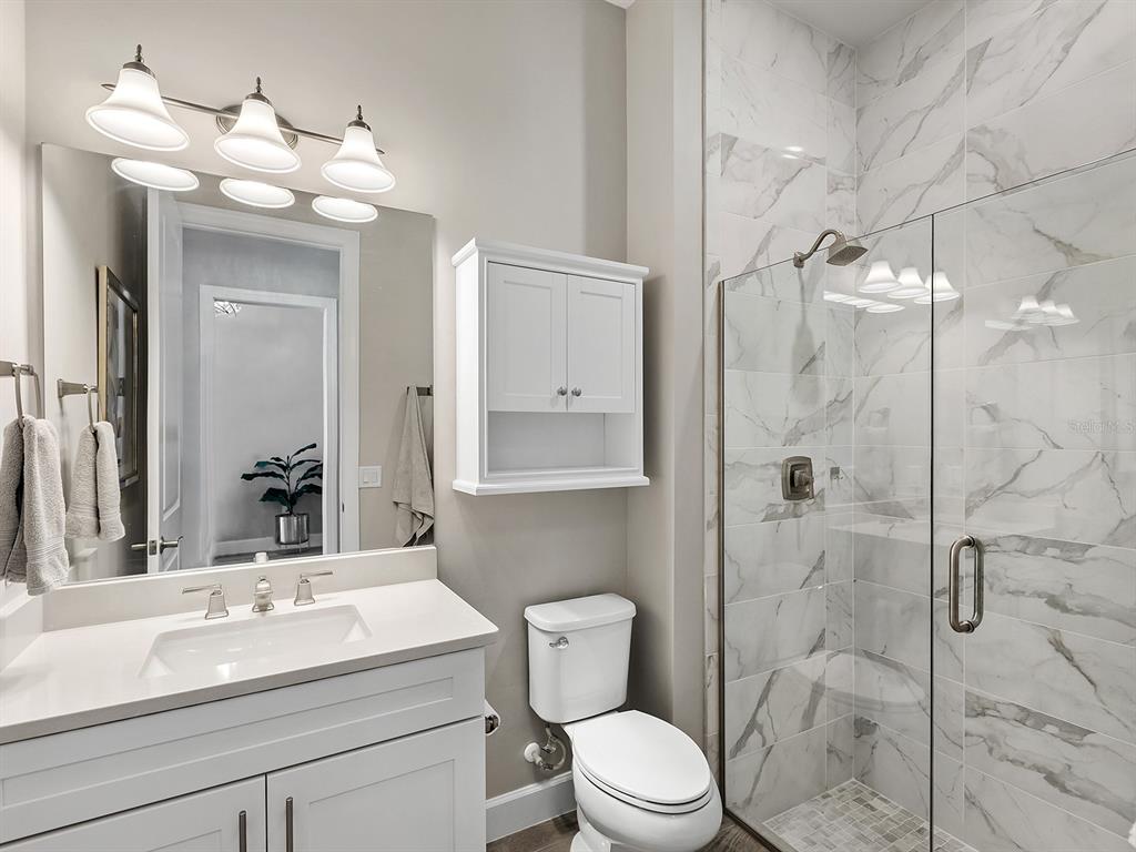 17807 Eastbrook Terrace Lakewood Ranch, FL 34202 - Photo 46 of 92 a bathroom with a sink a toilet and shower