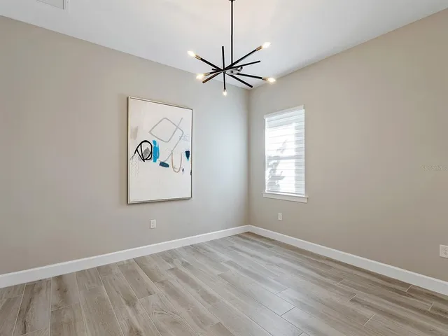 a living room with pool table and a chandelier