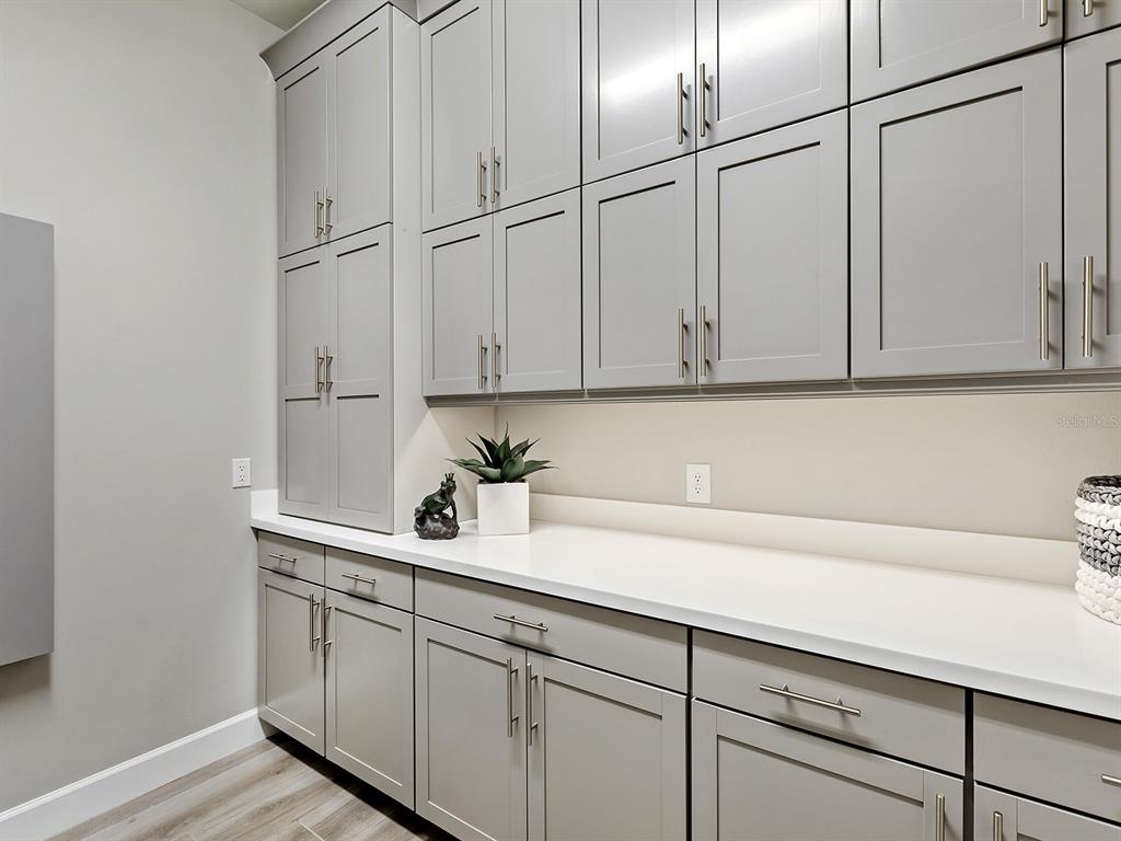 17807 Eastbrook Terrace Lakewood Ranch, FL 34202 - Photo 50 of 92 a kitchen with stainless steel appliances white cabinets and a sink