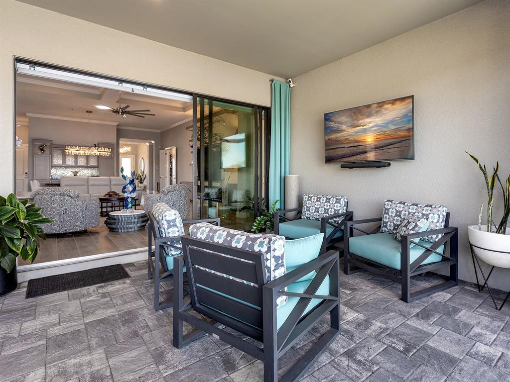 17807 Eastbrook Terrace Lakewood Ranch, FL 34202 - Photo 55 of 92 a living room with furniture and a flat screen tv