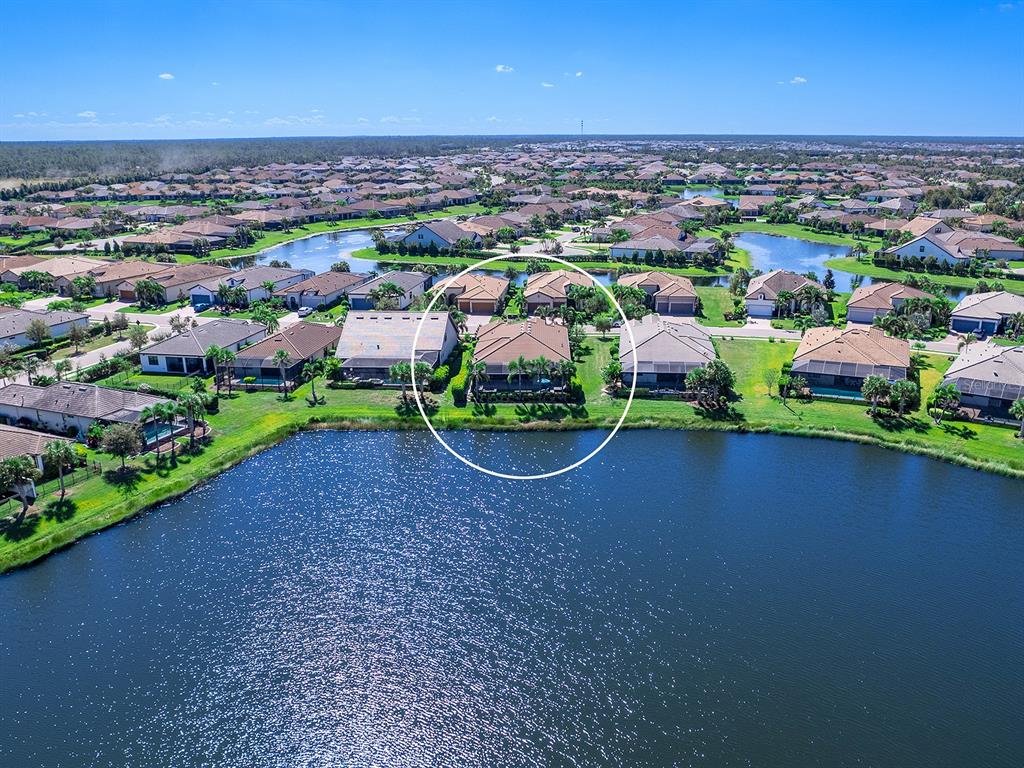 17807 Eastbrook Terrace Lakewood Ranch, FL 34202 - Photo 71 of 92 an aerial view of a house with a garden and lake view
