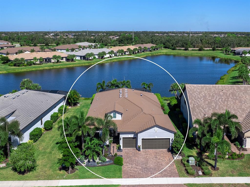 17807 Eastbrook Terrace Lakewood Ranch, FL 34202 - Photo 73 of 92 an aerial view of a house with a garden and lake view
