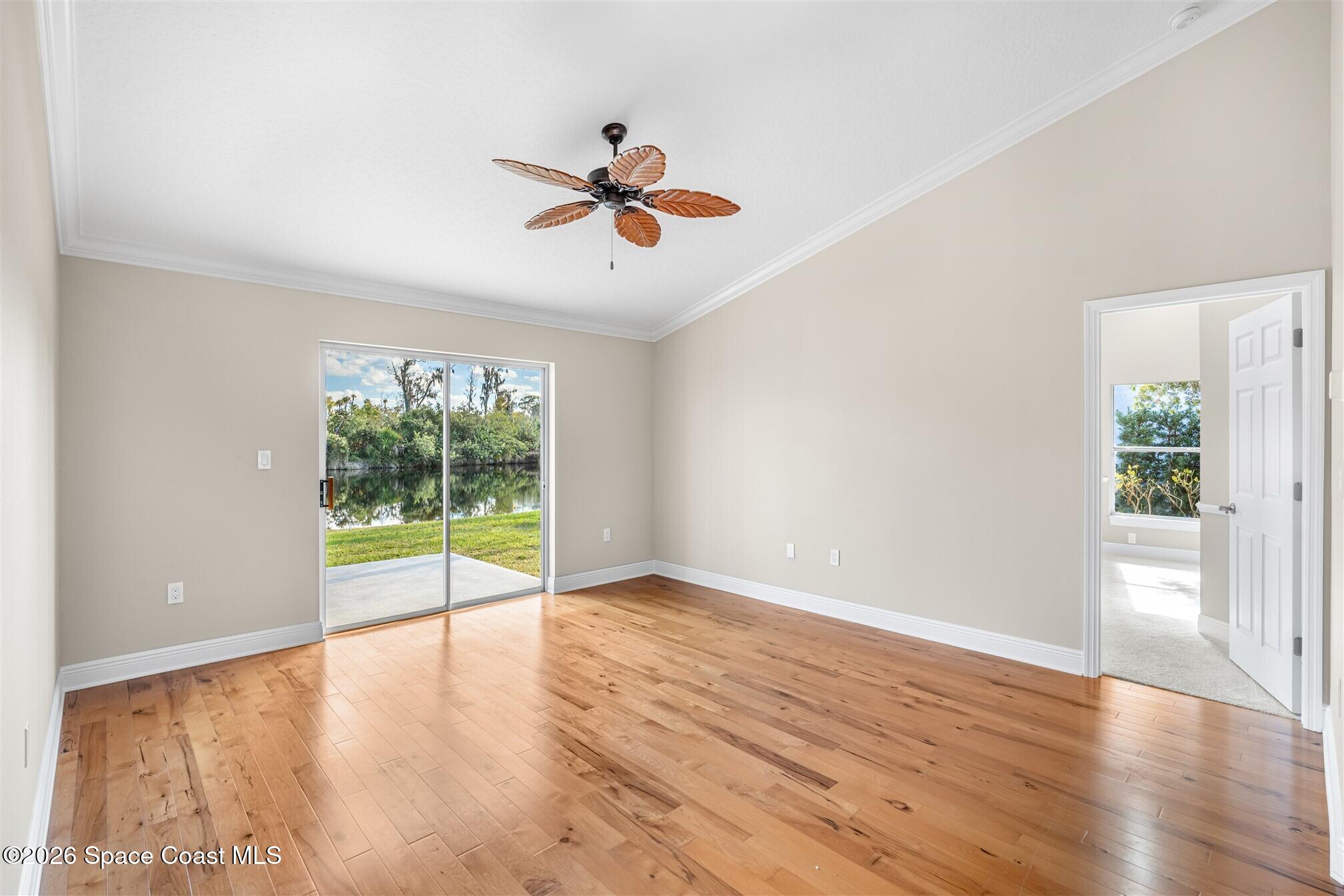 8033 Kingswood Way Melbourne, FL 32940 - Photo 14 of 70 wooden floor in an empty room with a window