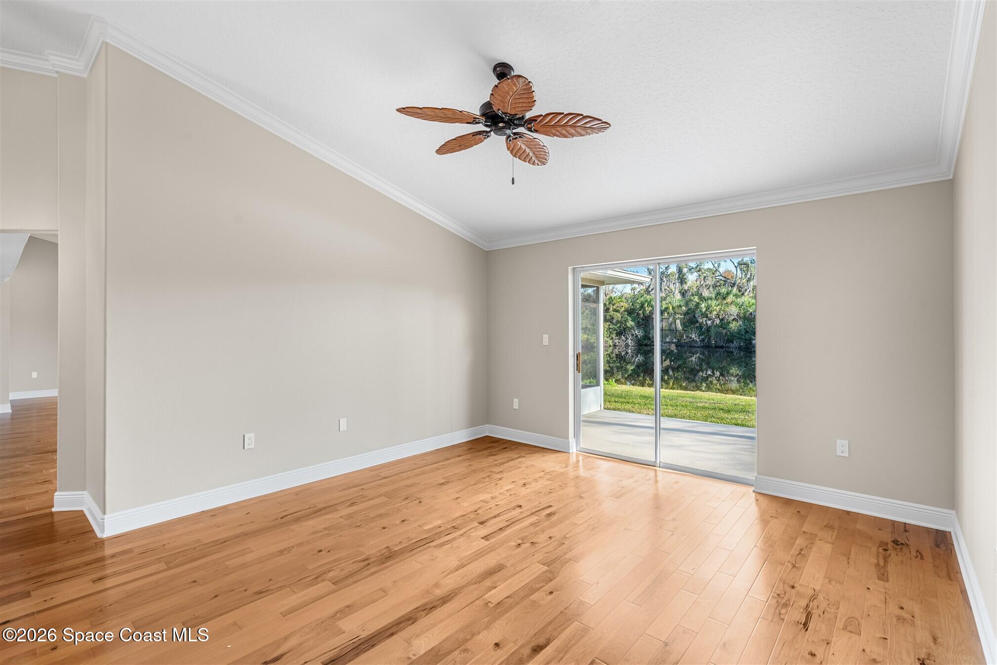 8033 Kingswood Way Melbourne, FL 32940 - Photo 16 of 70 wooden floor in an empty room with a window