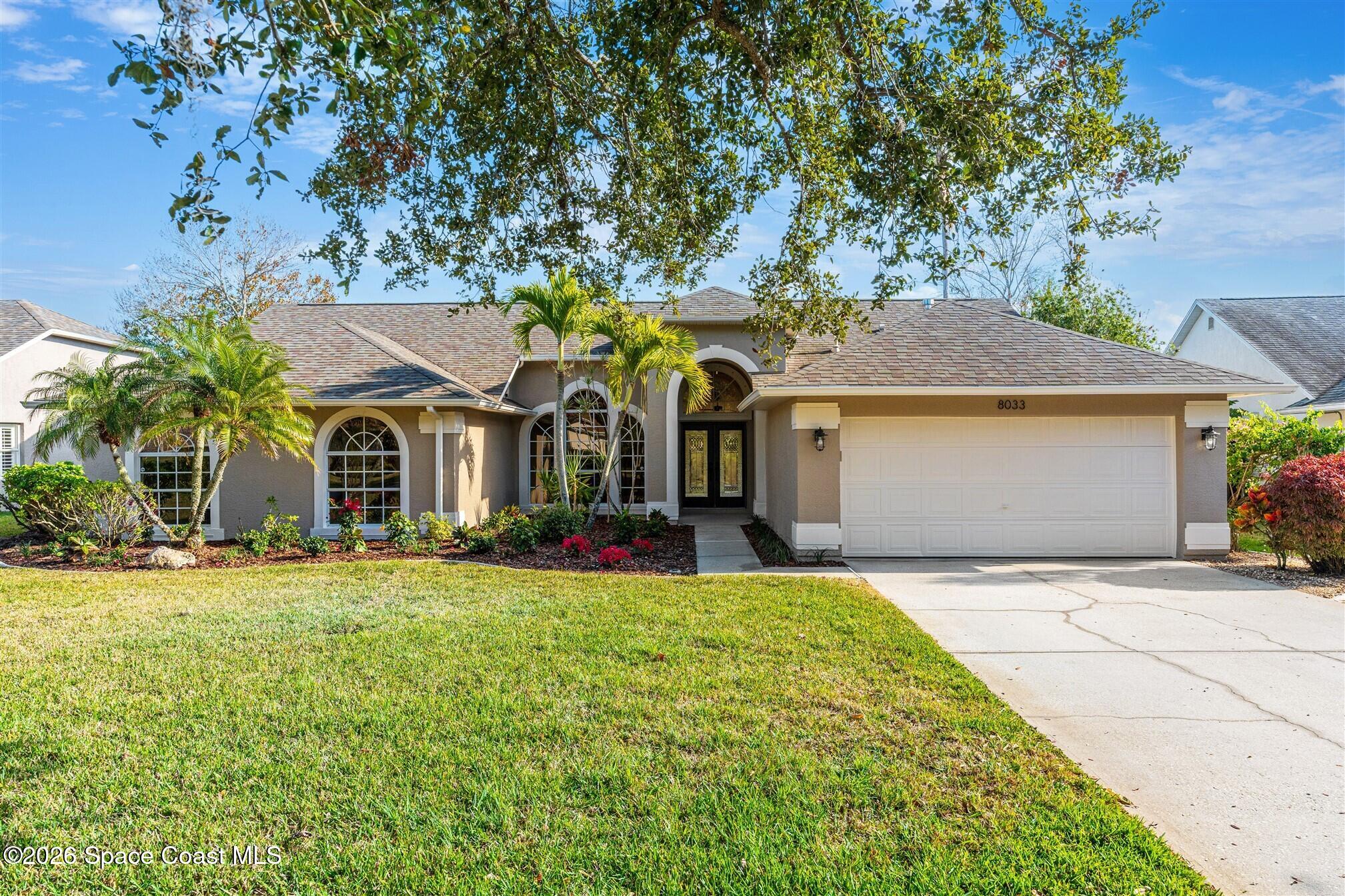 8033 Kingswood Way Melbourne, FL 32940 - Photo 2 of 70 a front view of a house with a yard and porch