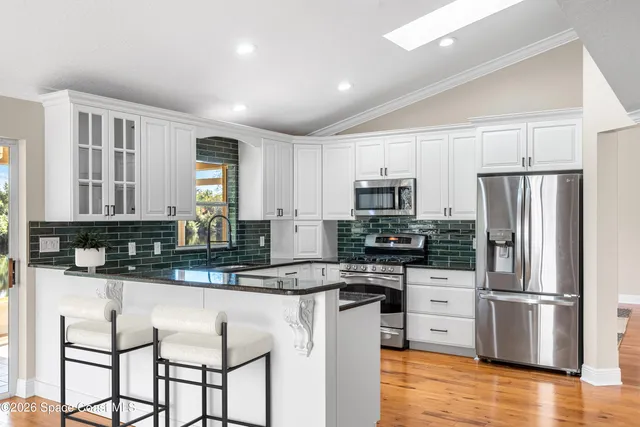 a kitchen with granite countertop white cabinets and a granite counter tops