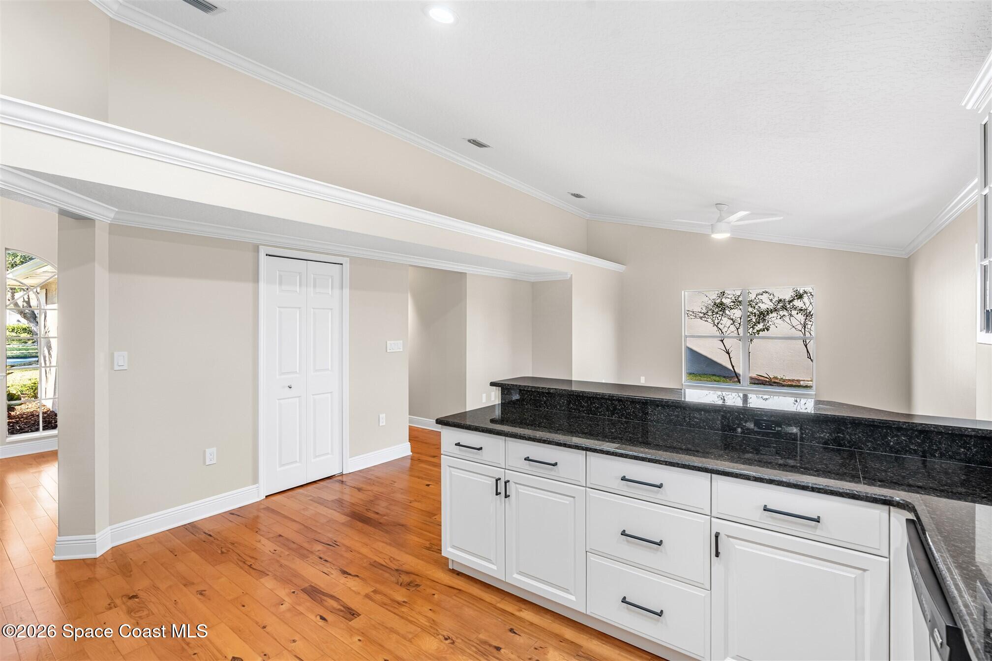 8033 Kingswood Way Melbourne, FL 32940 - Photo 25 of 70 a kitchen with granite countertop white cabinets and a granite counter tops