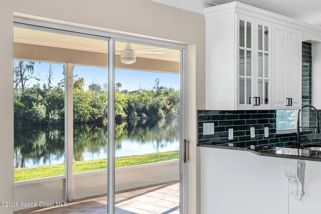 a bathroom with a granite countertop double vanity sink a mirror and a shower