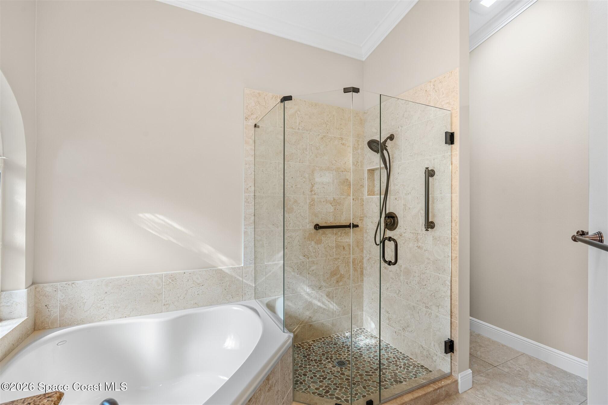 8033 Kingswood Way Melbourne, FL 32940 - Photo 36 of 70 a bathroom with a bath tub and shower